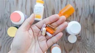 vitamins to avoid after surgery including bariatric multivitamin capsules and supplement tablets on wooden surface